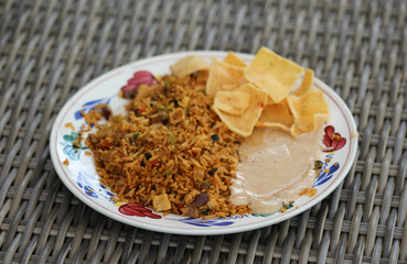 Obraz na płótnie Canvas Plate with Indonesian nasi goreng with peanut sauce and Krupuk