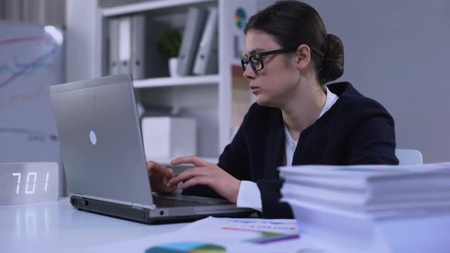 Female office employee feeling unhappy about workload, having no time for rest