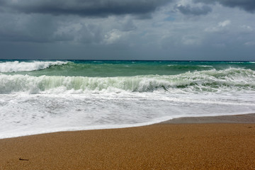 Fototapeta na wymiar Waves On sand beach of the Aegean Sea in Rhodes.