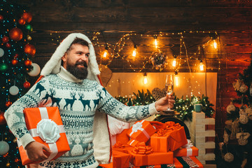 Christmas man in santa hat. Bearded modern santa claus in knitted sweater. New year christmas...