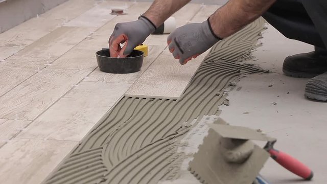 Laying tiles in bathroom