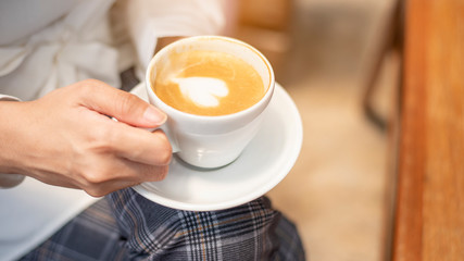 close up of beautiful  woman is drinking coffee