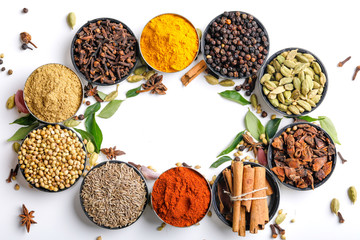 Various spices in a bowls on white background. Top view with copy space.