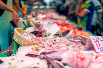 Fish counter at the grocery market in Barcelona. Bright colours, selective focus, bokeh.