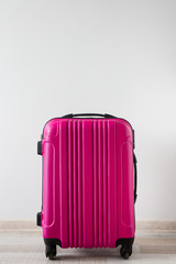 travel concept - pink suitcase over white background with copy space