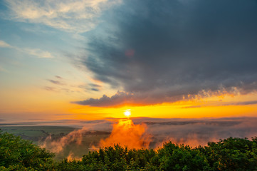 Obraz premium Dawn on a misty morning on a mountain above the river