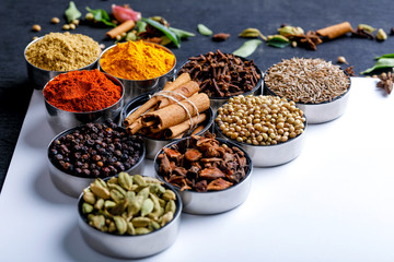 Various spices in a bowls on white background. Top view with copy space.