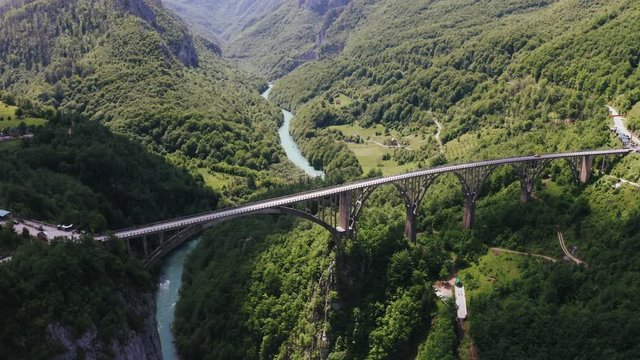 Aerial view footage of Durdevica Tara arc bridge in the mountains of Montenegro