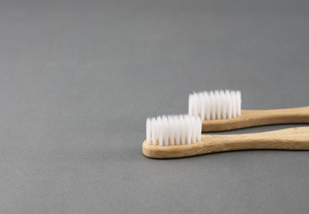 Fototapeta na wymiar Close up wooden toothbrush on grey background, selective focus