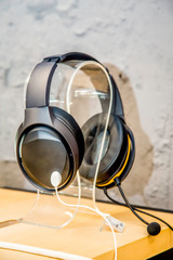 modern headphones in the store are on a light wooden table background