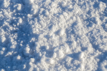 Snow after snowfall - snow lying in snowdrifts after the last snowfall. Photo in the winter in the field.