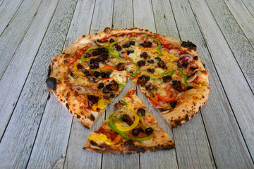 Tasty vegetarian pizza on a wooden surface