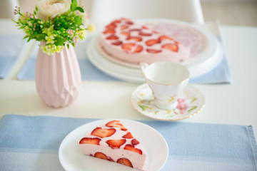 Fresh cheesecake with strawberries on a table