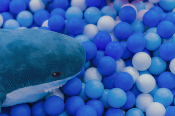 Colorful balls and shark stuffed animals.