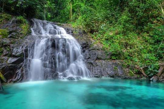 Tropical waterfall in the forest and mountain ,Ton Chong Fa in khao lak Phangnga South of Thailand. horizontal landscape, left.