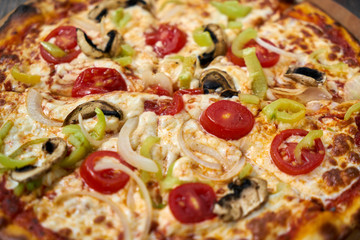 Delicious pizza with vegetables on the table