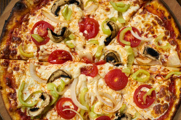 Delicious pizza with vegetables on the table