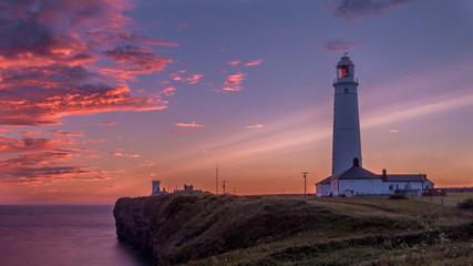 Nash Point Lighthouse at sunset. The lighthouse is in South Wales, on the Welsh Coastal Path.