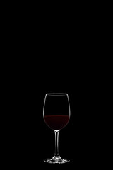 Wineglass with red wine isolated on black background