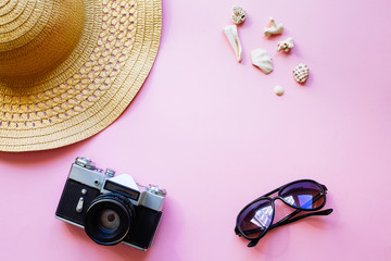 Flat lay design of travel concept with camera, hat, shells