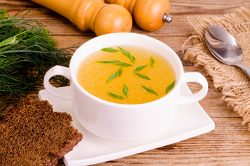 Chicken broth soup in white plate. Photo