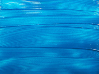 three-dimensional strokes of blue paint on a white background