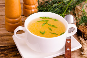 Chicken broth soup in white plate. Photo