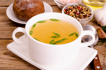Chicken broth soup in white plate. Photo