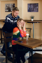 A man meets a woman in a cafe, the guy doesn’t noticeably sneak up and close his eyes to the...