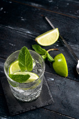 Gin with clean water and ice in a glass Cup - alcoholic cocktail with lime and mint