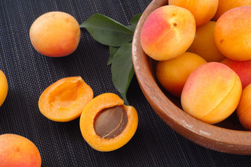 Organic apricots in a wooden bowl