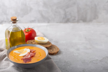 Salmorejo cordobes typical spanish tomato soup similar to the gazpacho, topped with jamon serrano and eggs