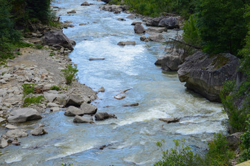 Fast blue mountain river flowing in summer. Beautiful natural background. Wildlife, forest.
