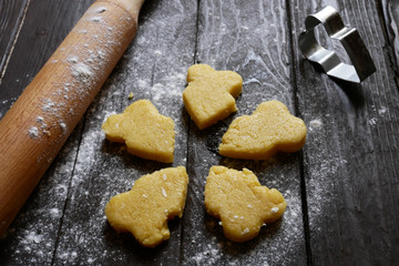 Cooking shortbread. Shortbread on the table with flour and rolling pin.
