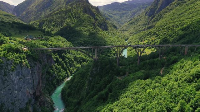 Aerial hyperlapse footage of Durdevica Tara arc bridge in the mountains of Montenegro. Clouds are moving fast