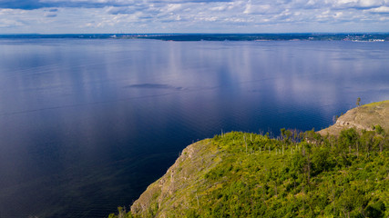 Fototapeta premium Aerial view from the drone of landscape Volga river flows among the hills and fields. The middle band of Russia.