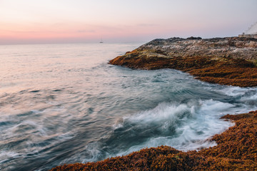 Long exposure image of Dramatic sky seascape with rock in sunset scenery background