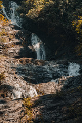 Obraz premium A multi level waterfall and cascade in a tropical rainforest, lampee waterfall in Phannga ,Thailand