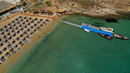 Aerial drone photo of famous organised with sun beds and umbrellas beach of Kalo Livadi with...