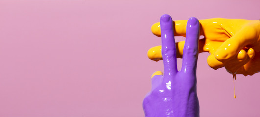 male hands in paint crossed in a hashtag sign on a colored background, creative advertising, social networks concept