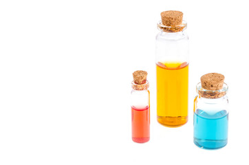 Glass medical bottles with colored liquid isolated on white. 