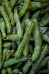 Organic fresh young green pods of beans in a crate for sale in the market.