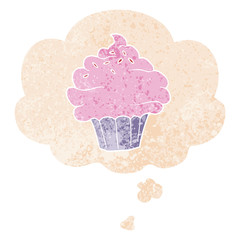 cartoon cupcake and thought bubble in retro textured style