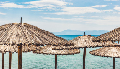 Straw umbrellas on tropical beach