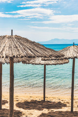 Straw umbrellas on tropical beach