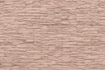 Rock stone brick tile wall aged texture detailed pattern background in cream red brown color