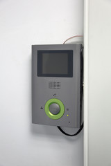 Modern electric door bell on the inner wall of the building