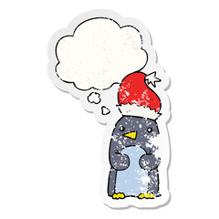 cute christmas penguin and thought bubble as a distressed worn sticker
