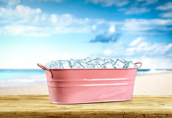 Desk of free space for your decoration and summer beach background with ice cubes 