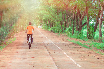portriat asian cute children on bicycle. lettle girl smilling and fun in park at thailand